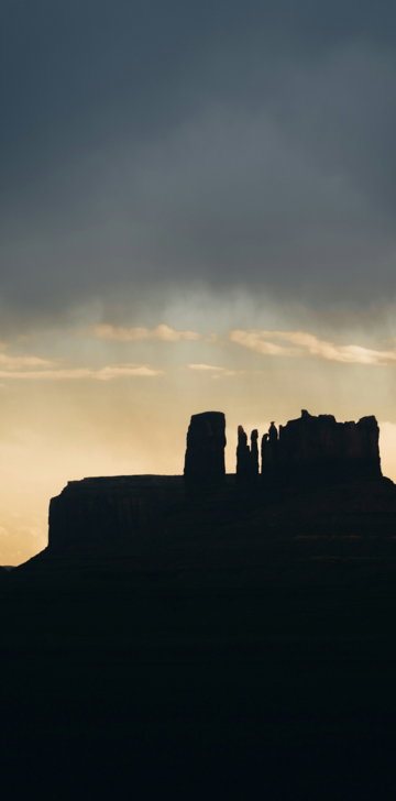silhouette-of-rock-formations-against-a-dramatic-sky.jpg Silhouette of rock formations against a dramatic sky