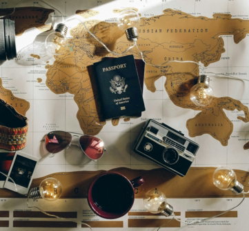 black-dslr-camera-near-passport.jpg black DSLR camera near passport