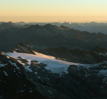 snow-capped-mountains-under-a-hazy-sunset-sky.jpg Snow-capped mountains under a hazy sunset sky